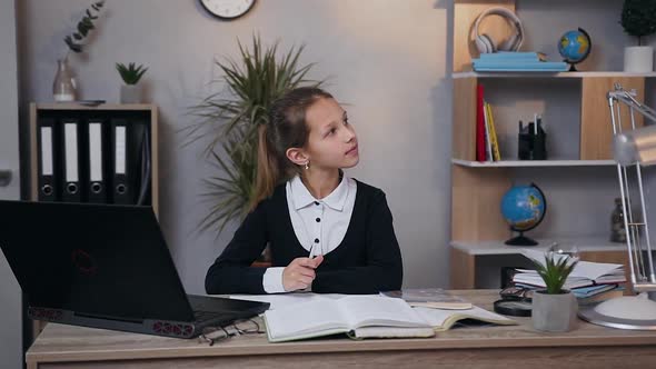 Dreamy Pretty Teen Girl in School Uniform Writing a Work at Home alt