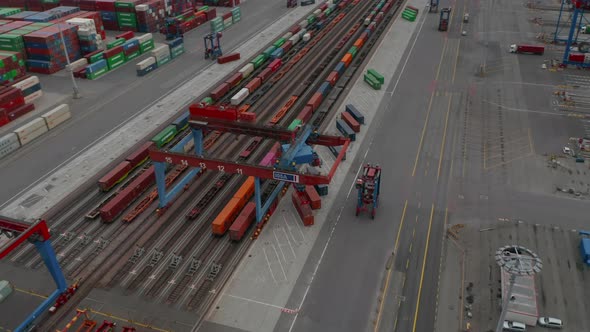 Aerial View of Forklift Driving in Commercial Cargo Terminal By Colorful Cargo Containers alt