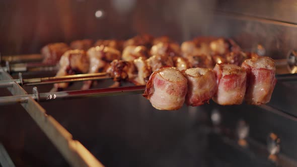 Drops of Fat Is Falling From Roasting Meat on Skewers in Chargrill, Close-up alt