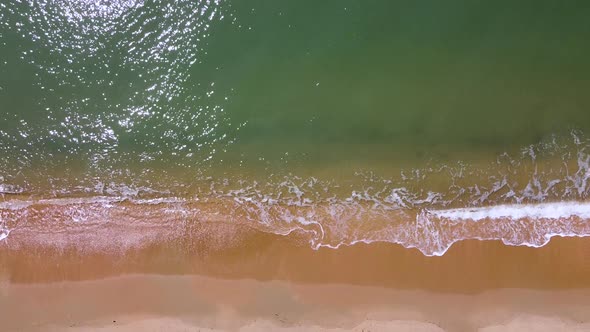 Small sea waves. Soft waves on a sandy beach. Seascape background