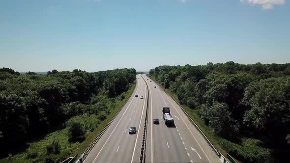 Aerial Shot Of A Highway Passing Through The Rural Countryside alt