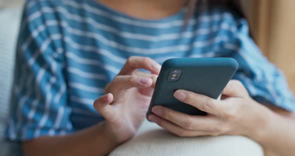 Woman mobile phone at home alt