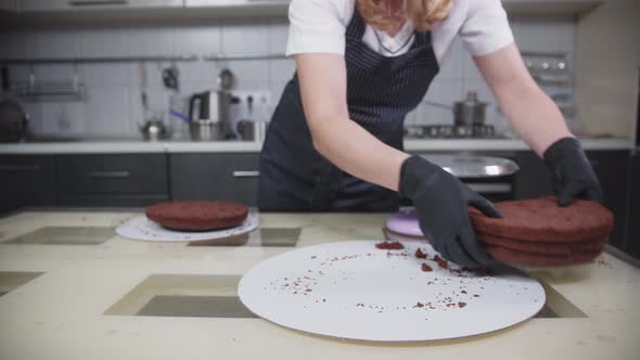 Confectionery  a Woman Puts Cake Bisquits on One Plate alt