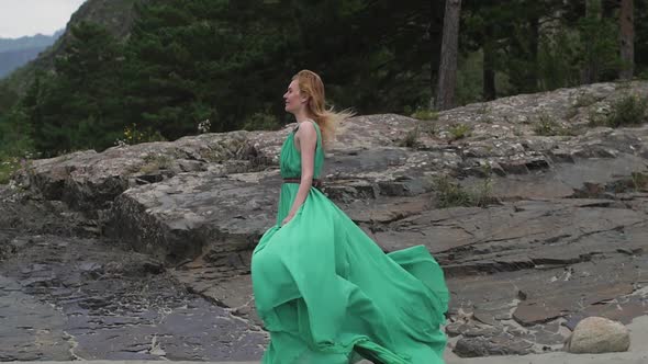 Young Woman in a Long Flowing Dress on the Background of the River and Mountains. Coloring Women alt