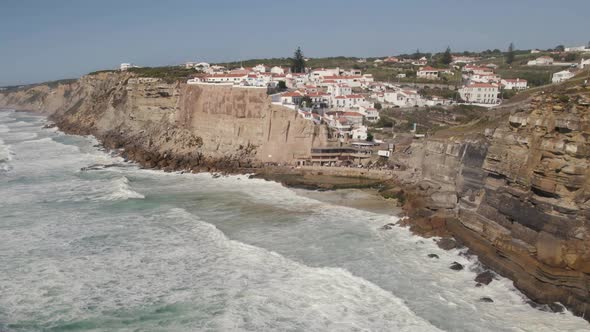 Strong waves washing on cliffs. Panoramic view of coastal town of Azenhas do Mar, Sintra, Portugal alt