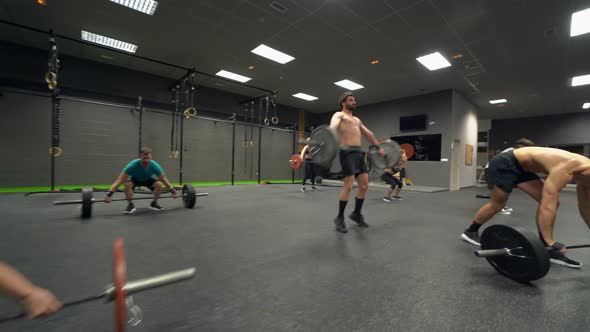 Group of athletes training weight lifting at gym