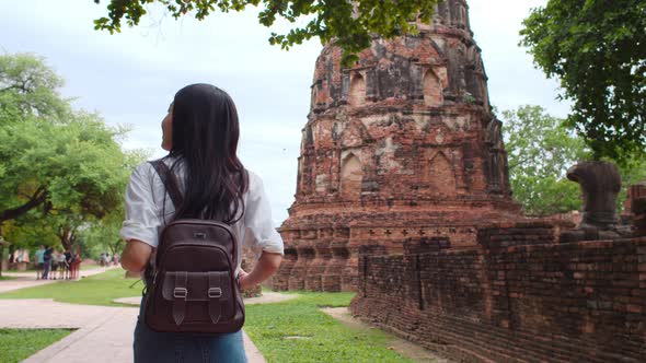 Japanese backpacker female enjoy her journey at amazing landmark in traditional city.