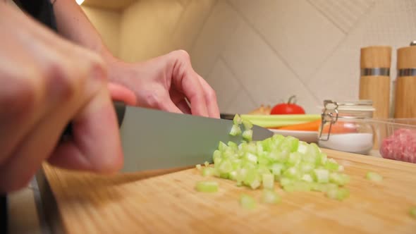 Woman Cuts Celery Slices alt