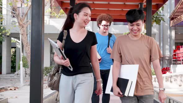 Education and student concept. Students walking and talking in university alt