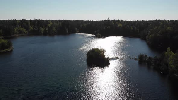 Wild Camping Small Island In Middle Of Lake And Sun Reflection On Water Aerial