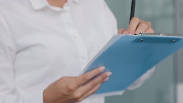 Closeup Unrecognizable Female Secretary Manager Hold Pen Makes Notes Writes Data in Note Tablet alt