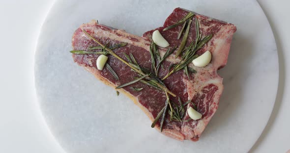 Fresh T-Bone or Porterhouse dry aged steak on marble cutting board. Marinate in olive oil alt