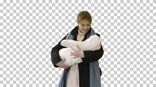 Young mother with her baby child outdoors at winter, Alpha Channel alt