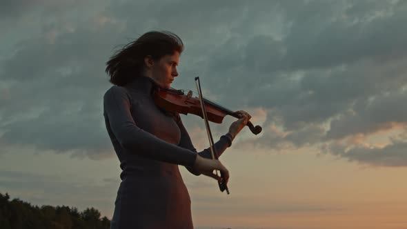 Woman Violinist Playing Solo On Sunrise