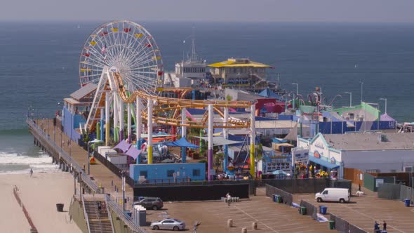 Aerial of Ferris wheel and amusement park rides at Pacific Park alt