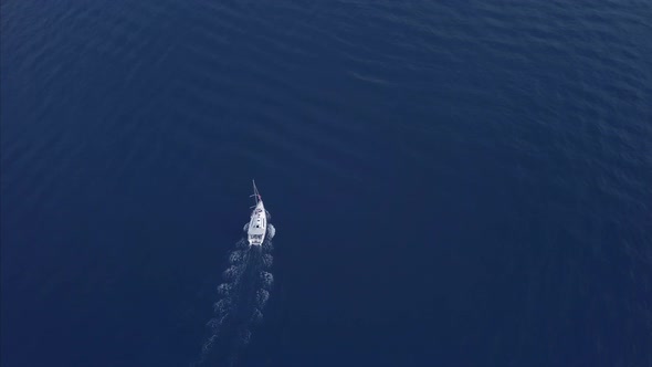 Aerial  Top View Of A Sail Going To Journey On Beautiful Blue Color Sea alt