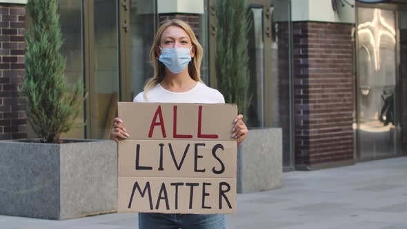 ALL LIVES MATTER Concept, No Racism. Outdoors Portrait of a Young Female Activist Wearing a Medical alt