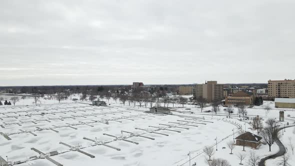 Drone view from frozen Lake Michigan marina on a cold, gray winter day.