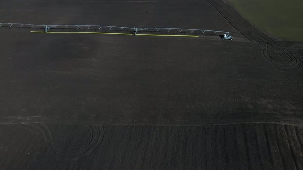 Aerial drone view drip irrigation watering system in agricultural farm field alt