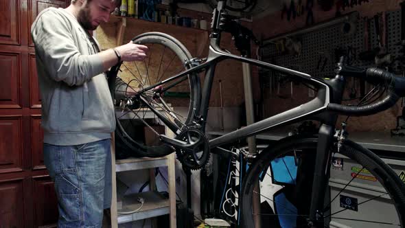 Mechanic Repairing Bicycle in Workshop