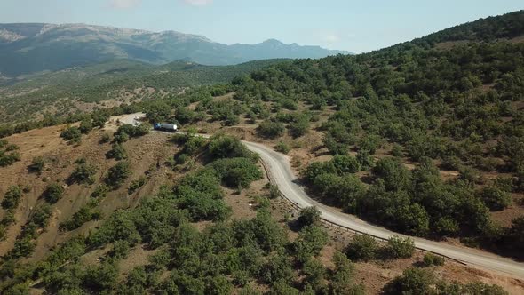 A Winding Road Through the Crimean Mountains Along the Sea alt