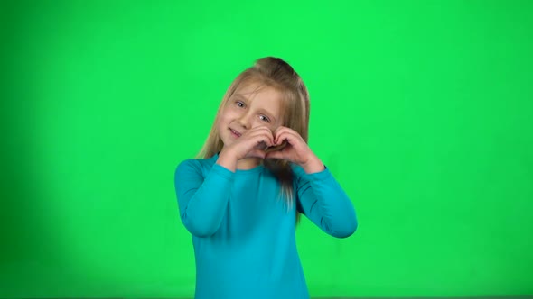 Blonde Girl Shows Hands of the Heart Then Making Air Kiss. Slow Motion alt