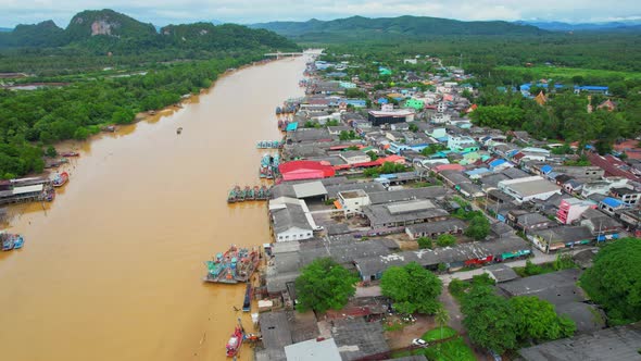 Aerial shot of river and local fisherman village beside the sea alt