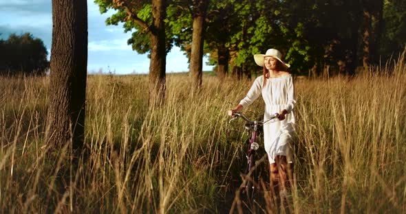 Woman Walking with Bicycle Countryside