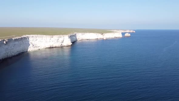 Drone footage of cliff and sea