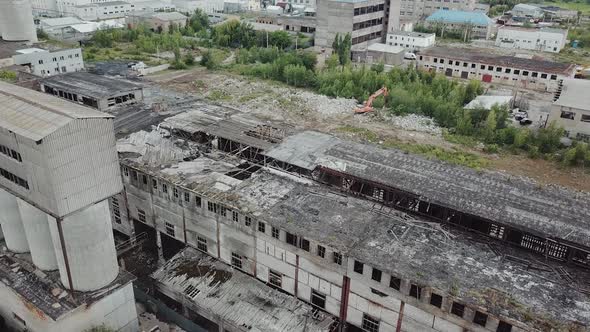 Flying over abandoned industrial factory buildings in very dilapidated condition. alt