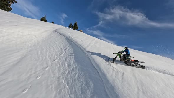 FPV Drone Male Snow Bike Drop From Cornice Into Soft Fluffy Iced Snowy Extreme Sport Slow Motion alt