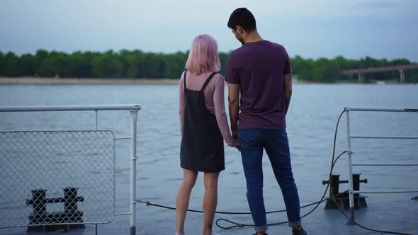 Wide Shot Happy Young Couple Standing on Urban Embankment Talking Admiring Beauty of Nature alt