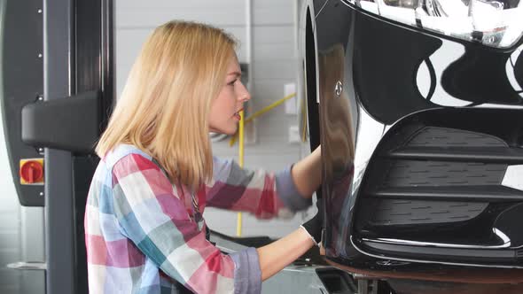Young Girl Learning To Fix a Car alt