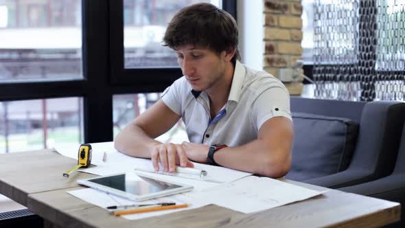 A civil engineer designs and works on drawings and analyzes the structure of a project. alt