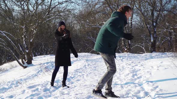Happy Couple Having Fun in Winter Forest alt