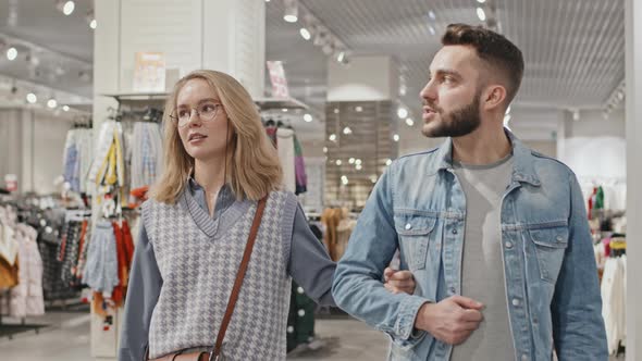 Stylish Young Couple Shopping In Clothing Store alt