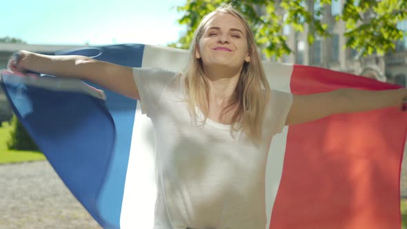 Blond Positive Caucasian Woman Spinning with French Flag on University Yard. Portrait of Charming alt