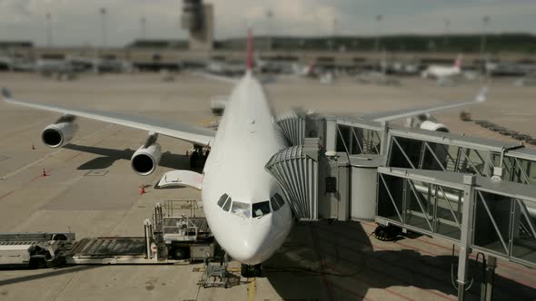 Large Commercial Airplane Airliner Standing at Airport Terminal Gate alt