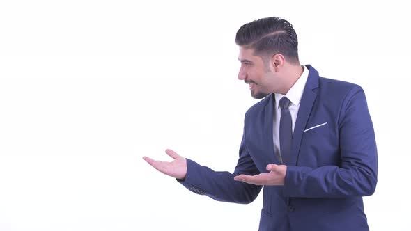 Happy Bearded Persian Businessman Showing Something alt