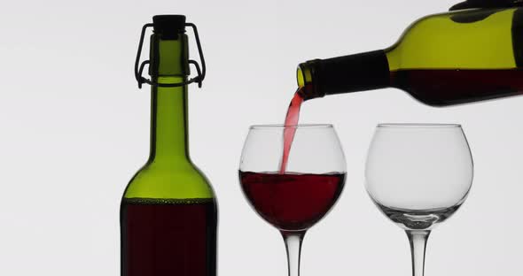 Rose Wine. Red Wine Pour in Two Wine Glasses Over White Background alt