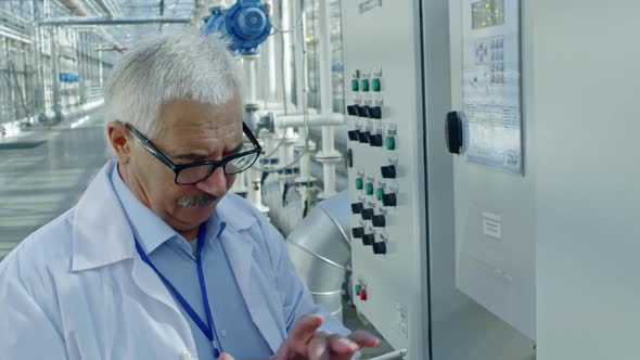 Agronomist Adjusting Climate Control in Greenhouse alt