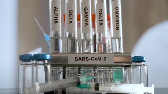 SARS COV 2 Test Tubes Labelled Alpha Gamma Delta Beta And Omicron Variants In Rack. Slow Zoom In alt