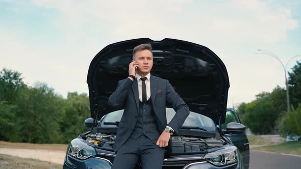 Young Man Using Smartphone Calling Car Assistance Services Standing By Breakdown Automobile alt
