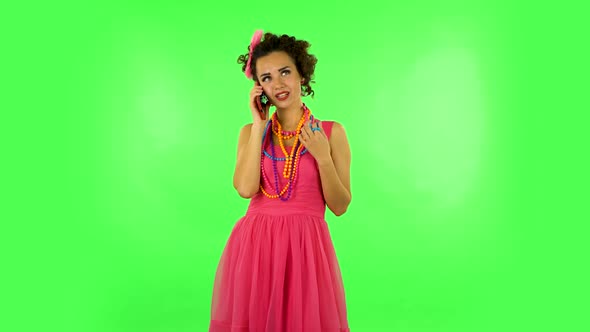 Portrait of Smiling Girl Talking for Mobile Phone and Rejoice. Green Screen alt