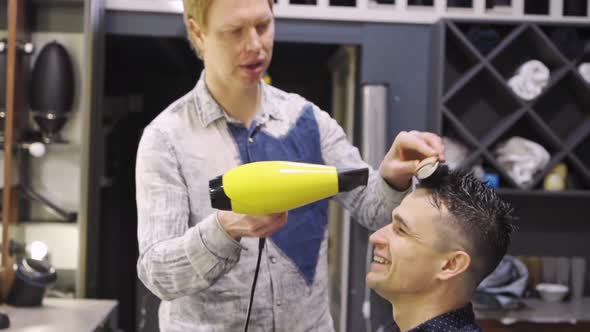 Hairdresser Dries Hair Dryer Brunette Man in a Barbershop alt