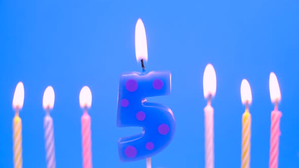 Light the Candle Number 5 for Birthday on Blue Background