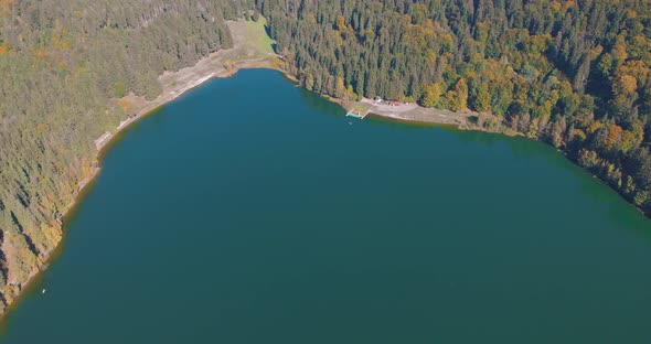 Aerial View Of St. Ana's Crater Lake In Romania During Autumn - drone shot alt