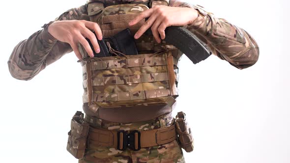 Special operations in multicam inserts loaded rifle magazines nto pouches at plate carrier