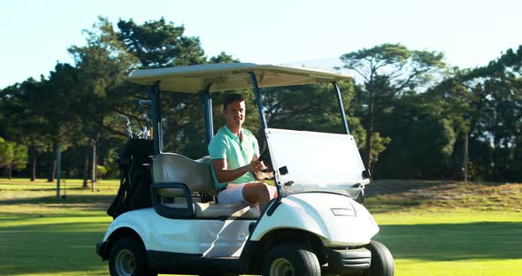 Golfer driving in his golf buggy alt