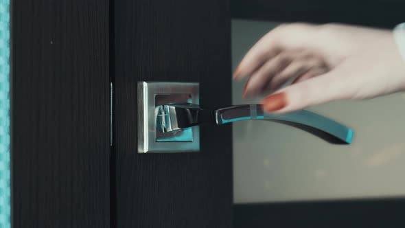 Woman Opens the Door and Leaves the Room at Home Door Handle Closeup Cinematic